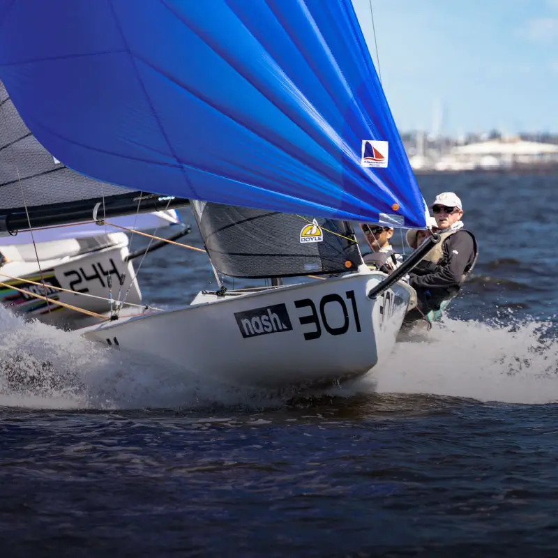 Sailboat racing with bright blue spinnaker