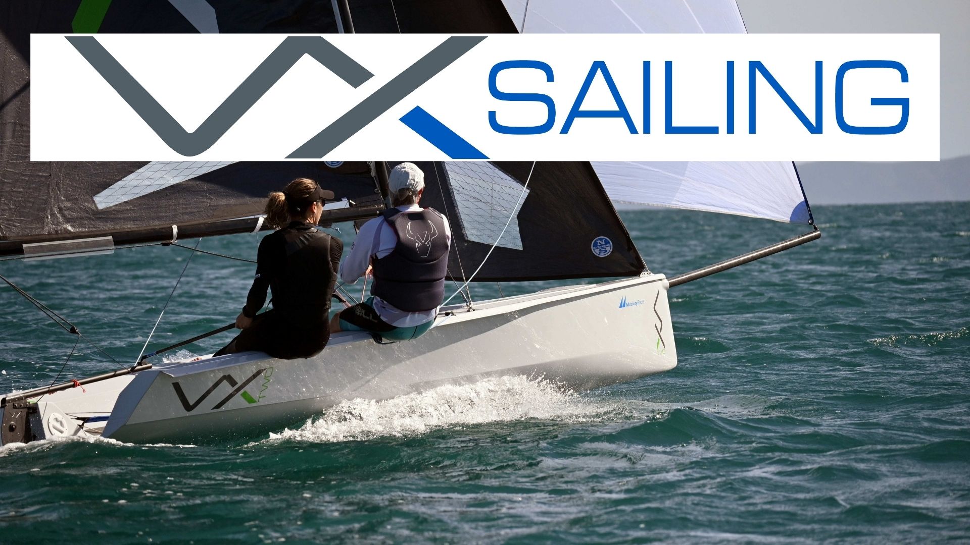 Two people sailing a VX boat on water