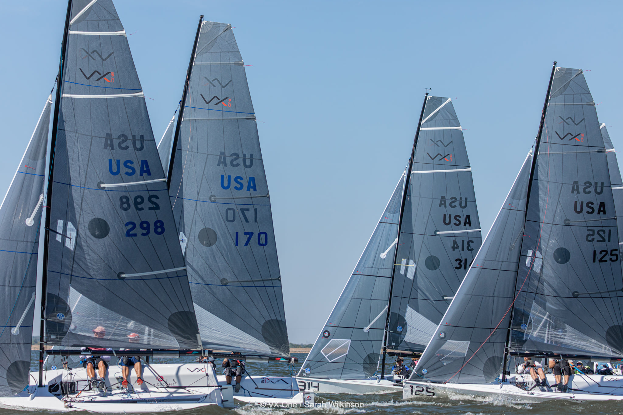 Sailboats racing on sunny ocean waters