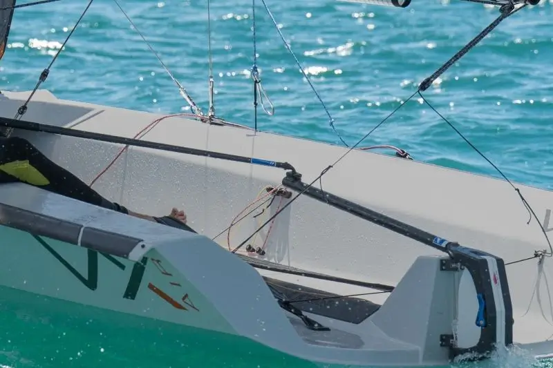 Sailing dinghy gliding across turquoise ocean water