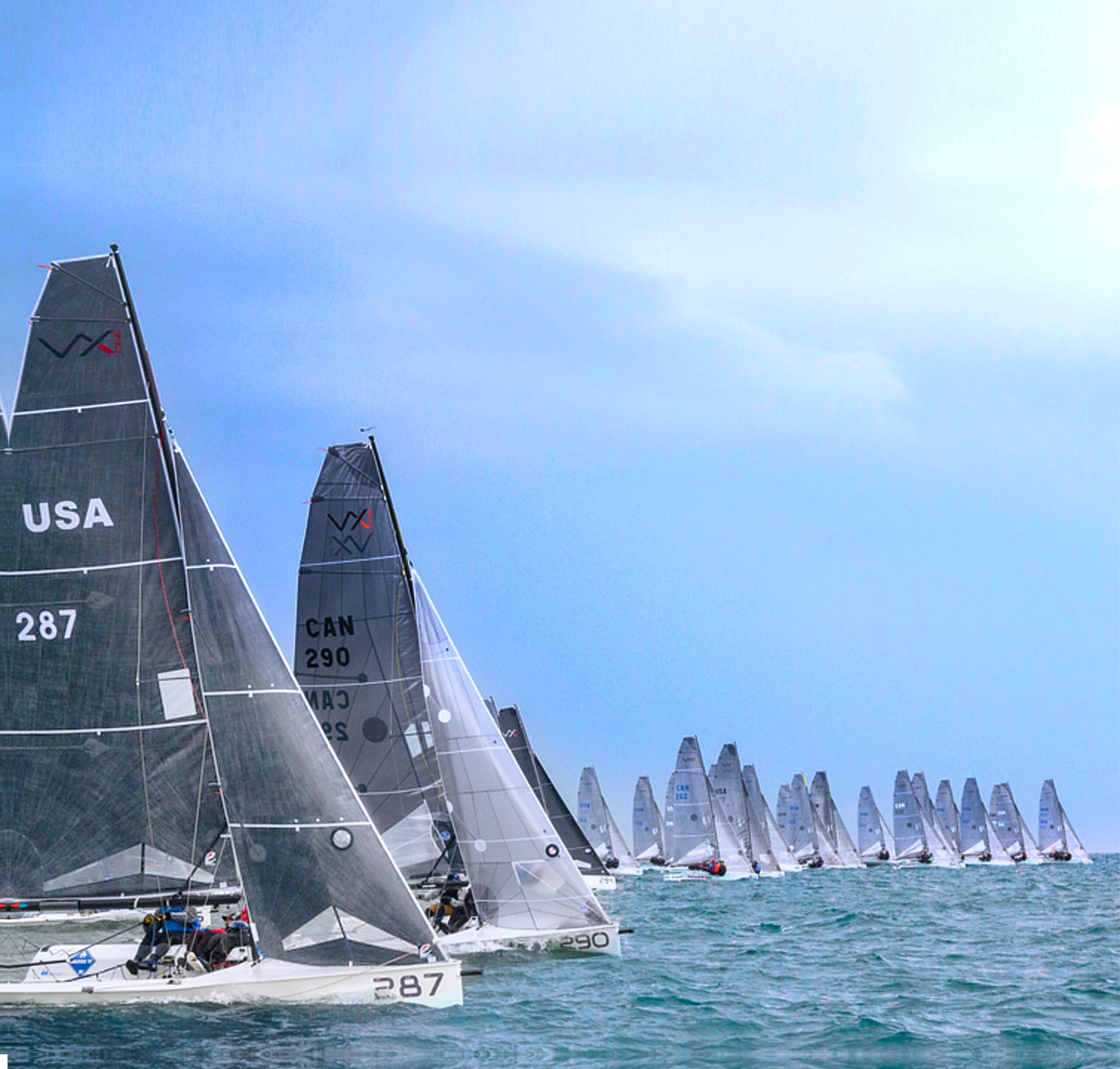 Sailboats racing on clear blue ocean water