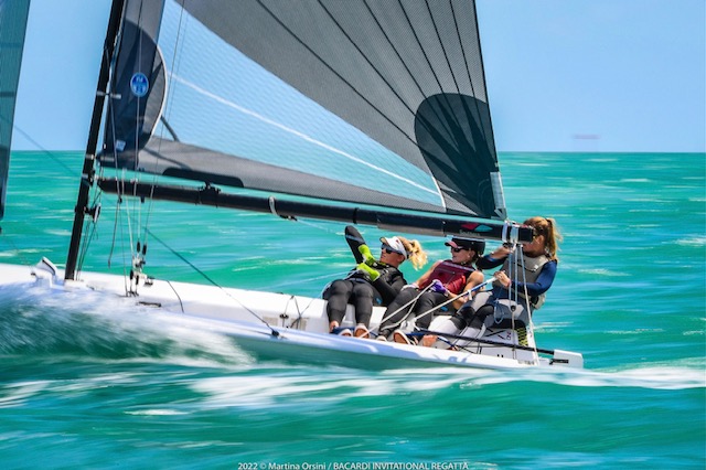 Crew sailing yacht during regatta in turquoise sea