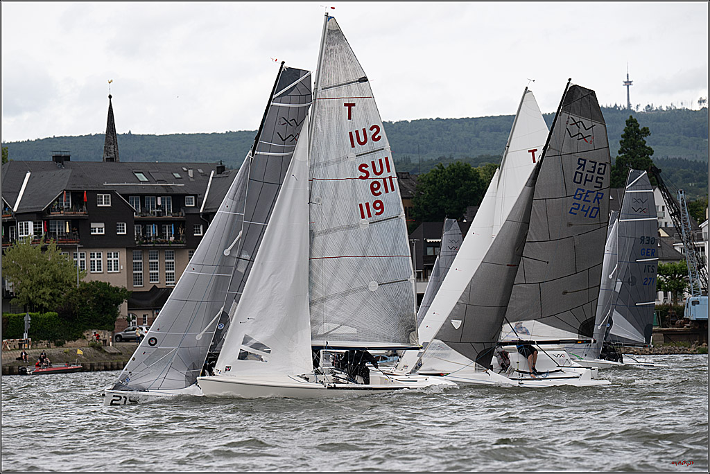 Sailboats racing on a windy lake near town