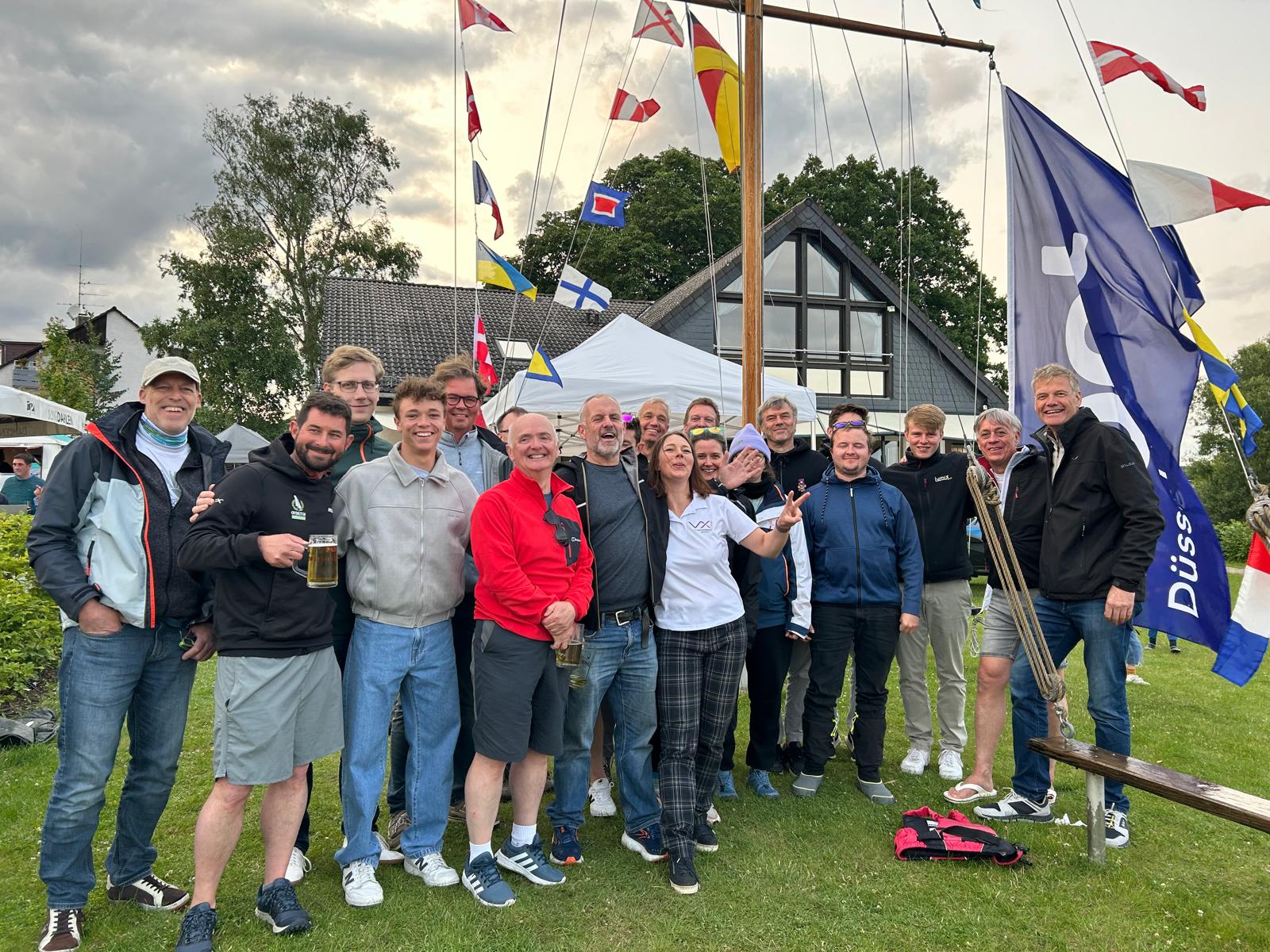 Group of people celebrating outdoors with flags