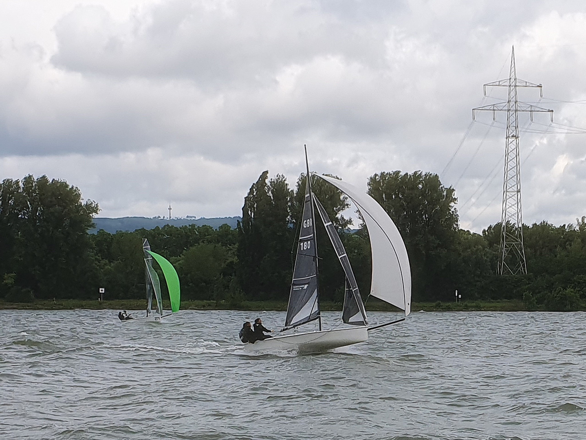 Two sailboats racing on a windy lake