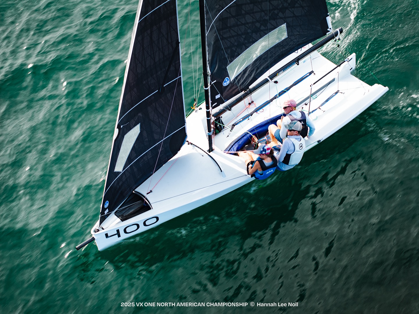 Sailboat racing on green ocean waters
